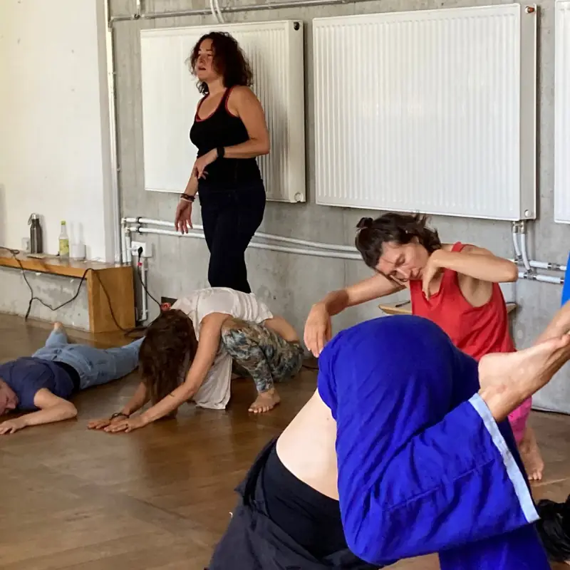 Transformational dance session with participants, including Pilar Valencia, moving freely